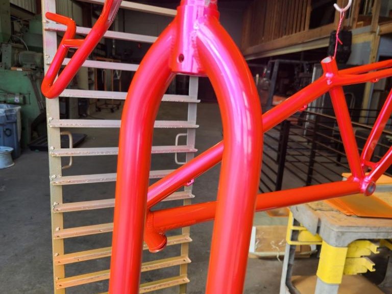 Vibrantly painted vehicle components in striking red at Armadillo Automotive and Powder Coating