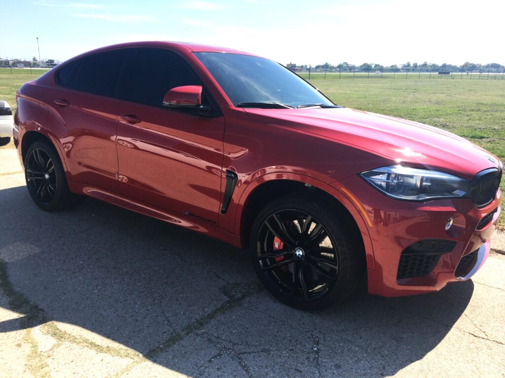 Stunning red car expertly painted by Armadillo Automotive in Kenner, showcasing the high-quality paintwork and attention to detail