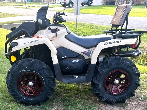 A Can-Am Outlander ATV equipped with specialized performance tires and aftermarket rims by armadillo automotive, kenner automotive